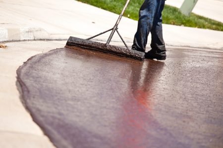 Road Worker Resurfacing Street with Hot Tar.